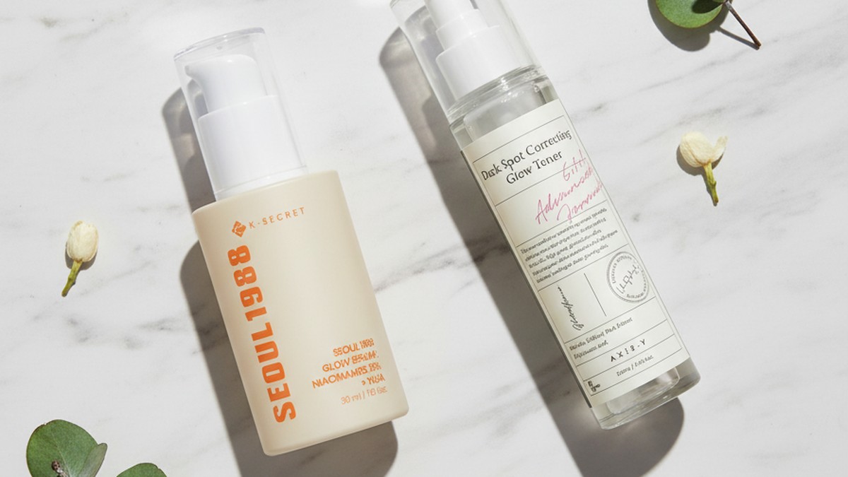 Brightening Korean skincare products arranged on a light surface with citrus slices